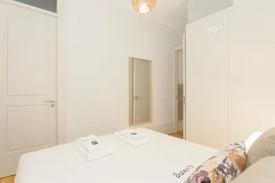 a white room with a couch and a mirror at Liiiving in Porto - Bolhao Garden Apartment in Porto