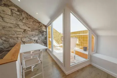 a room with a table and a large window at Alegria Duplex by Hosty in Porto