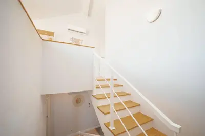 a staircase in a house with white walls and wooden floors at Alegria Duplex by Hosty in Porto