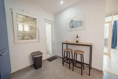 a room with a bar with two stools and a window at Alegria Duplex by Hosty in Porto
