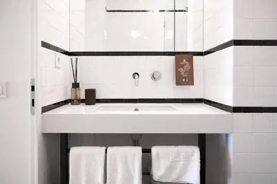 a bathroom with a white sink and white towels at Take me to Aliados in Porto