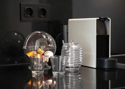 a group of glasses on a counter next to a microwave at Take me to Aliados in Porto