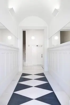 a hallway with a black and white checkered floor at Take me to Aliados in Porto