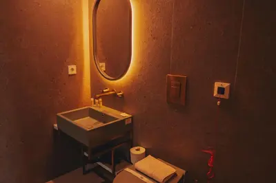 a bathroom with a sink and a toilet and a mirror at Domum 4 in Porto