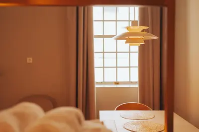 a dining room table with two chairs and a window at Domum 4 in Porto