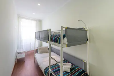 a bedroom with two bunk beds and a window at GuestReady - Lightform Apartment in Porto