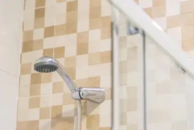 a shower with a shower head in a bathroom at GuestReady - Lightform Apartment in Porto