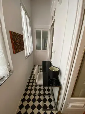 a bathroom with a black and white checkered floor at Aliados Historic Downtown Apartments by LuxiStay in Porto