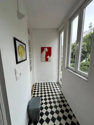 a hallway with a black and white checkered floor at Aliados Historic Downtown Apartments by LuxiStay in Porto