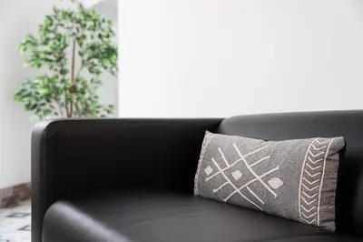 a black couch with a gray pillow on it at GuestReady - Serene Hideout in Downtown in Porto
