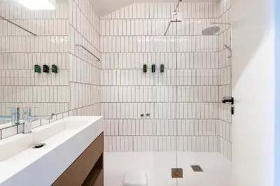 a bathroom with two sinks and a shower at Aires Gouveia Penthouse in Porto