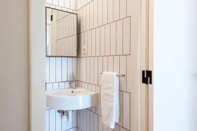 a bathroom with a sink and a mirror at Aires Gouveia Penthouse in Porto