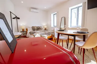 a living room with a red car in a room at Authentic Porto Village in Porto