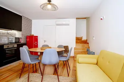 a living room with a table and chairs and a couch at Authentic Porto Village in Porto