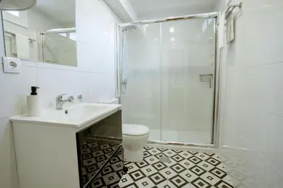 a bathroom with a shower and a sink and a toilet at Authentic Porto Village in Porto