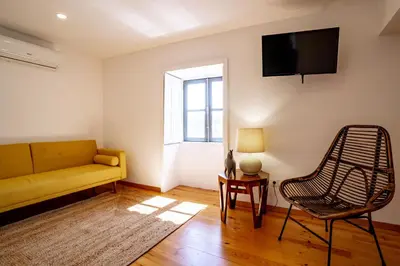 a living room with a couch and a chair at Authentic Porto Village in Porto