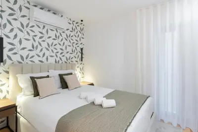 a bedroom with a white bed with towels on it at GuestReady - Tranquil haven in the city centre in Porto