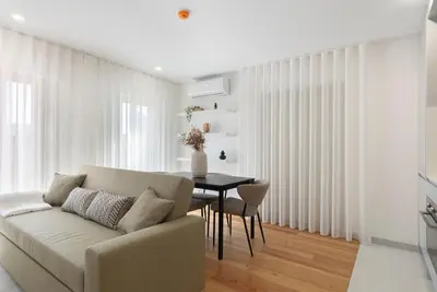 a living room with a couch and a table at GuestReady - Tranquil haven in the city centre in Porto