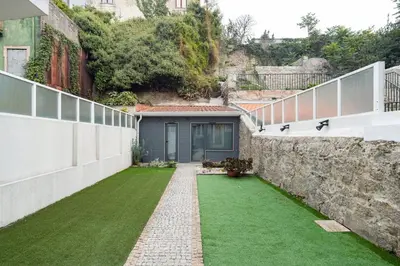 an internal courtyard of a house with a green lawn at GuestReady - Le Jardin Secret in Porto