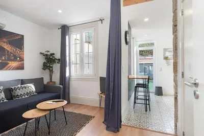a living room with a blue couch and a table at GuestReady - Le Jardin Secret in Porto