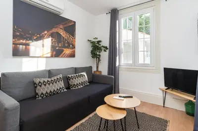 a living room with a couch and a table at GuestReady - Le Jardin Secret in Porto