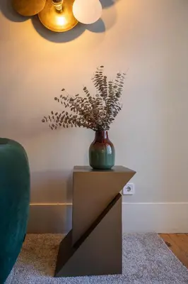 a vase on a table with a plant in it at 42 1T Cardosas Block Historic Ap in Porto