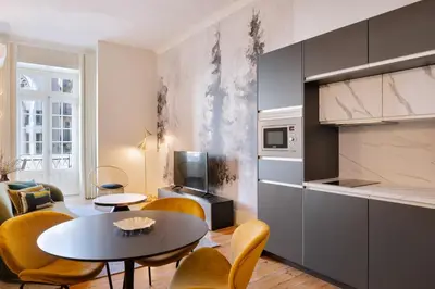 a kitchen and living room with a table and chairs at 42 1T Cardosas Block Historic Ap in Porto