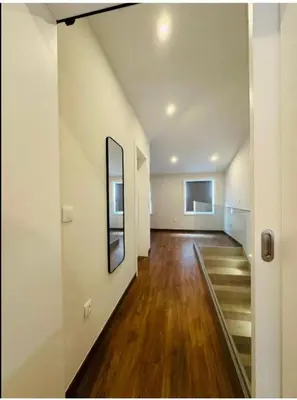 an empty room with a hallway with wood floors at Bridge Apartment in Porto