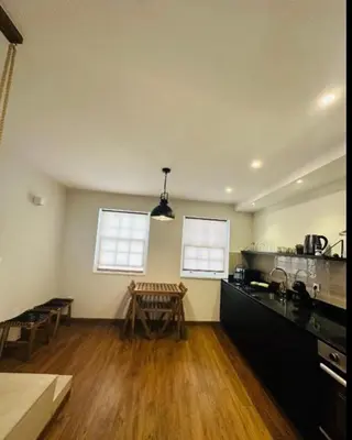 a kitchen with a counter and a table in it at Bridge Apartment in Porto