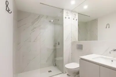 a bathroom with a shower and a toilet and a sink at GuestReady - Trendy getaway in the heart of Porto in Porto