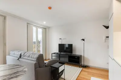 a living room with a couch and a tv at GuestReady - Trendy getaway in the heart of Porto in Porto