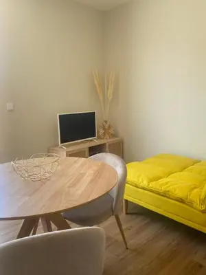 a living room with a table and a yellow bed at Peter Terrace - Rio Douro & Caves Vinho do Porto in Bandeira