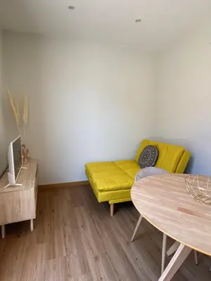 a living room with a yellow couch and a table at Peter Terrace - Rio Douro & Caves Vinho do Porto in Bandeira