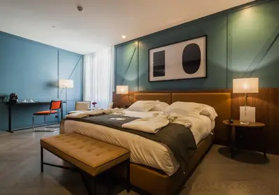 a bedroom with a large bed and a table at Vincci Porto in Porto