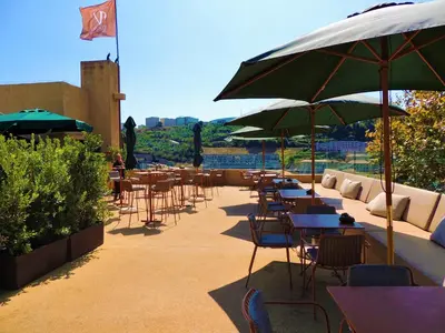 a group of tables and chairs with umbrellas at Vincci Porto in Porto