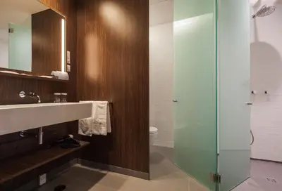 a bathroom with a sink and a glass shower at Vincci Porto in Porto