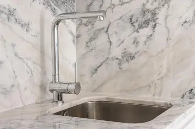 a kitchen sink with a faucet on a marble counter at GuestReady - Prince's Palace - HighLife in Porto