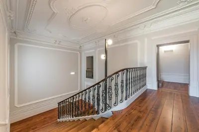 a staircase in a room with a white ceiling at GuestReady - Prince's Palace - HighLife in Porto