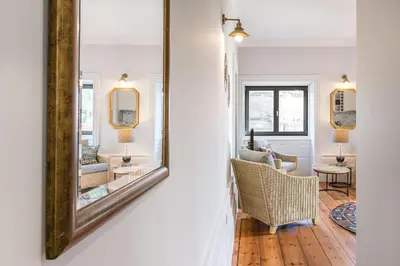 a mirror on a wall next to a living room at GuestReady - Prince's Palace - HighLife in Porto
