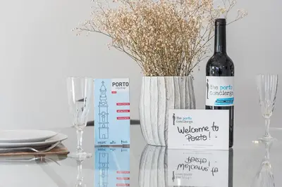 a bottle of wine sitting next to a vase with flowers at GuestReady - Prince's Palace - HighLife in Porto