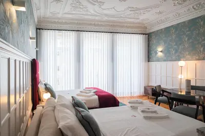 a bedroom with a couch and a bed and a table at HM Loios charming loft in Porto