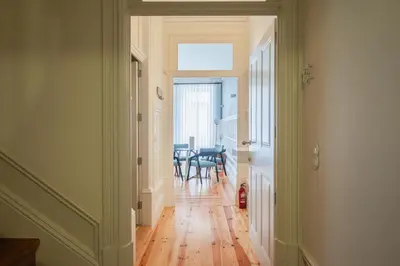 a hallway with a table and chairs in a room at HM Loios charming loft in Porto