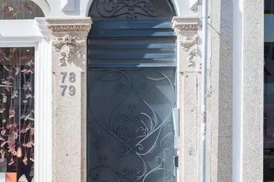 a black door with a number on a building at HM Loios charming loft in Porto
