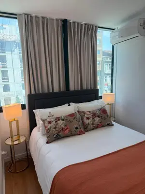 a bedroom with a bed with pillows and a window at ML Porto Plaza Avenue in Porto