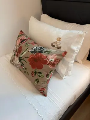two pillows sitting on top of a bed at ML Porto Plaza Avenue in Porto
