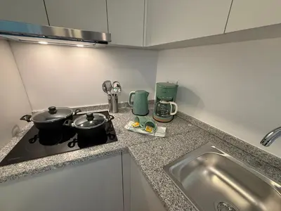 a kitchen counter with two pots and pans on a stove at ML Porto Plaza Avenue in Porto