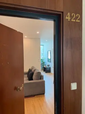 a door leading into a living room with a couch at ML Porto Plaza Avenue in Porto