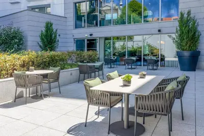 a restaurant with tables and chairs and a couch at Cenica Porto Hotel, Curio Collection By Hilton in Porto