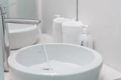 a sink with water pouring into it in a bathroom at GuestReady - Over the Bridge in Porto