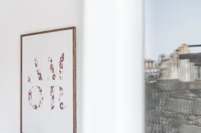 a picture frame with the word now on it next to a window at GuestReady - Over the Bridge in Porto